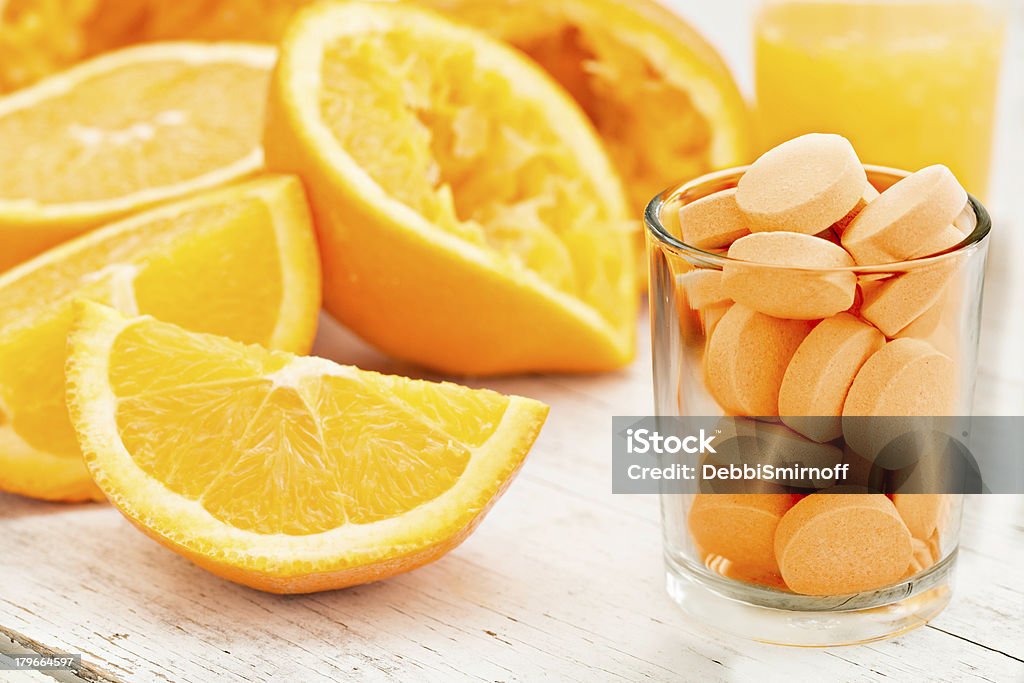 Sliced oranges and vitamin C tablets in a jar