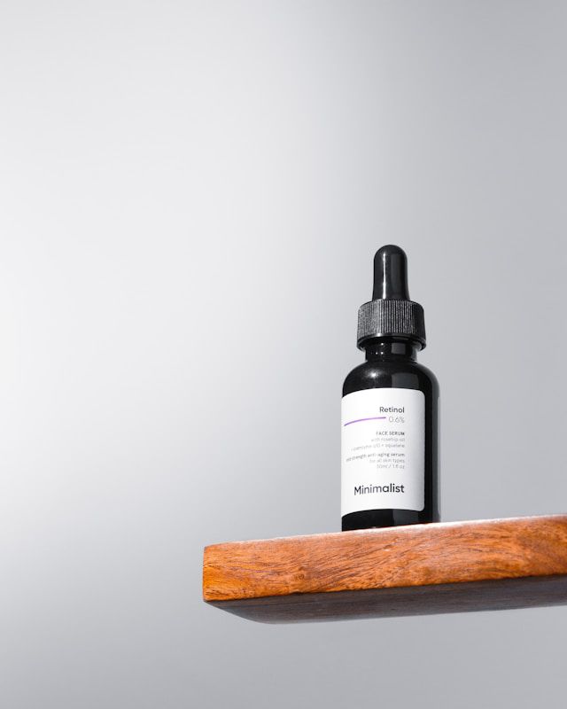 A bottle of retinol sitting on a plank of wood